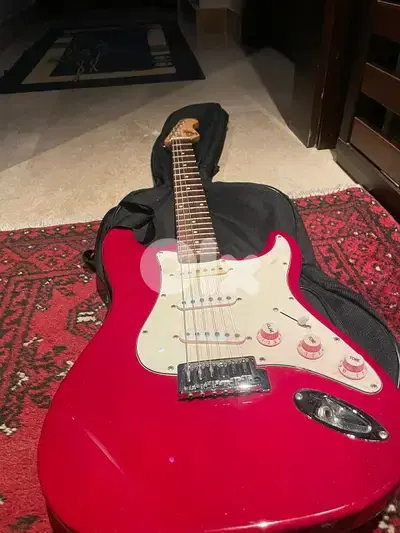 red on white stratocaster with amp and cables